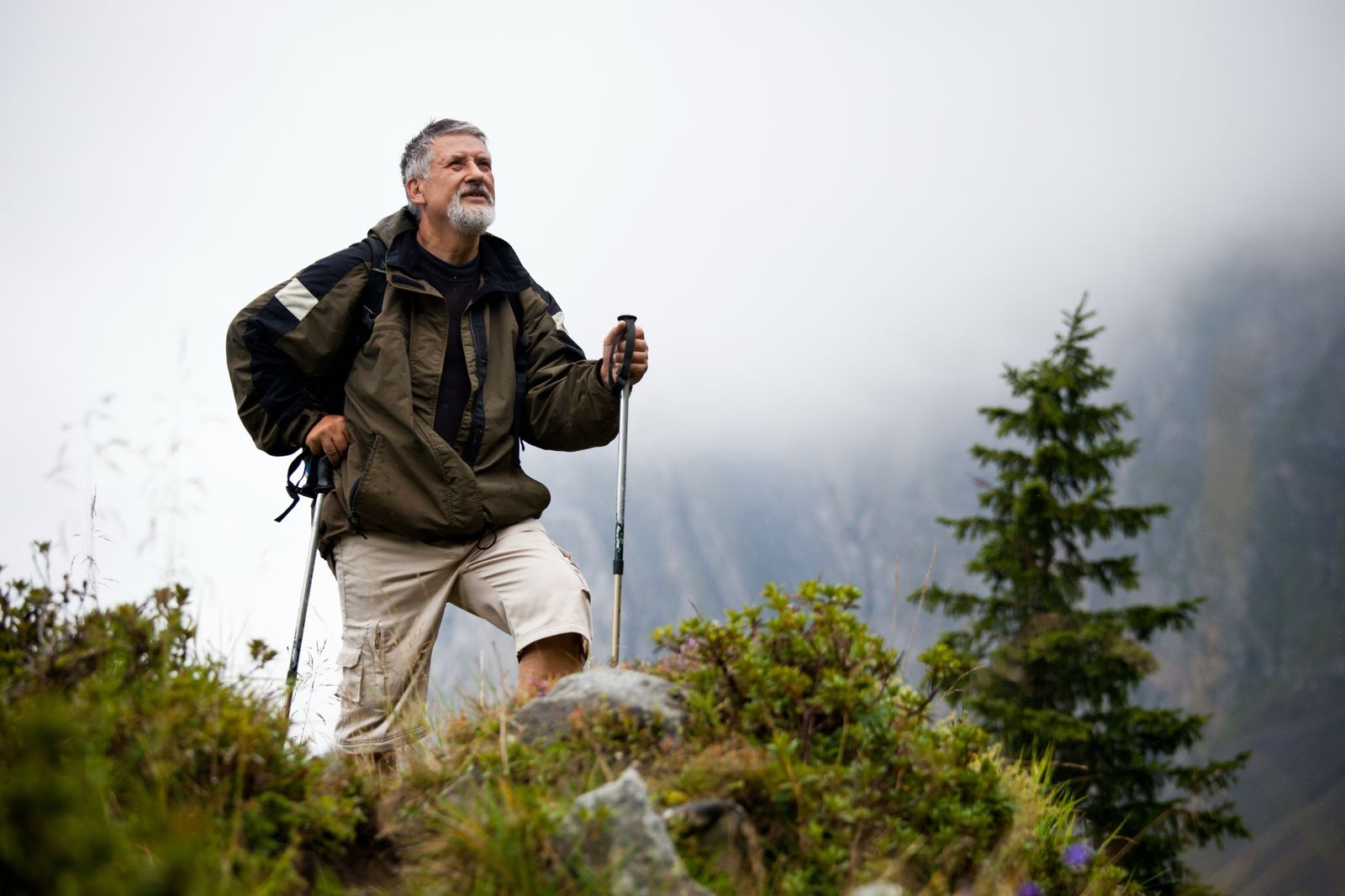 Retiree hiking on a mountain trail